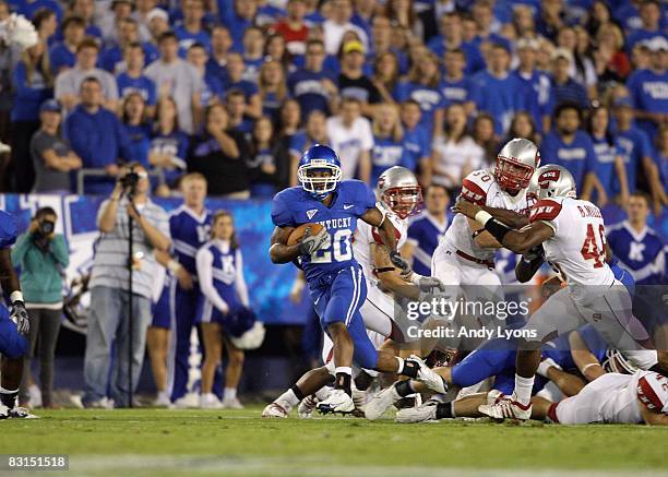 Derrick Locke of the Kentucky Wildcats runs with the ball during the game against the Western Kentucky Hilltoppers at Commonwealth Stadium on...