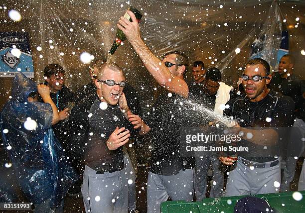 Howell, James SHields and Carlos Pena of the Tampa Bay Rays celebrate in the locker room with his teammates after their 6-2 win against the Chicago...