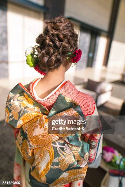 rear view of young woman in furisode kimono for coming of age ceremony - seijin no hi stock pictures, royalty-free photos & images