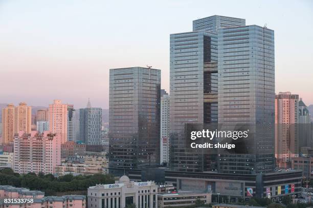 urumqi cityscape at sunset - urban skyline xinjiang stock pictures, royalty-free photos & images