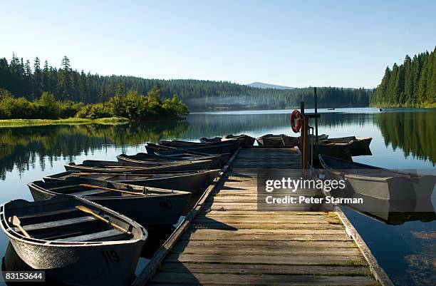 docked row boats used for lake fishing - oregon stock-fotos und bilder