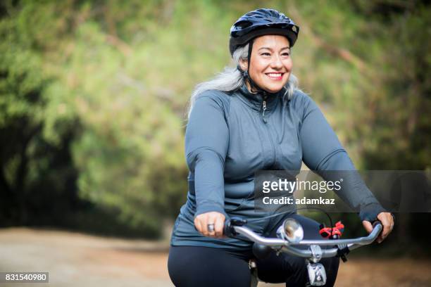 beautiful mexican woman biking - sports helmet stock pictures, royalty-free photos & images