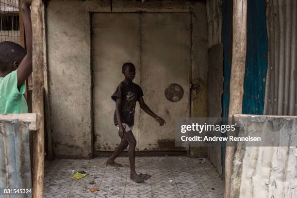 Boy plays soccer in the Mathare North neighborhood on August 14, 2017 in Nairobi, Kenya. Nairobi remained peaceful, but tensions remain high as...