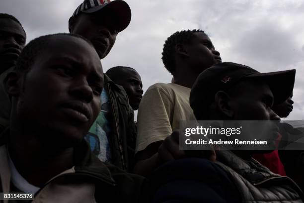 Men listen to local members of parliament speak regarding election fraud in the Lucky Summer neighborhood on August 14, 2017 in Nairobi, Kenya....