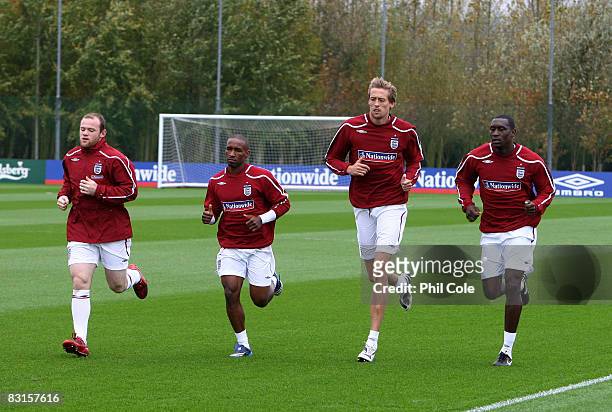 Wayne Rooney, Jermaine Defoe, Peter Crouch and Emile Heskey of England warm up during the England training session at London Colney on October 7,...