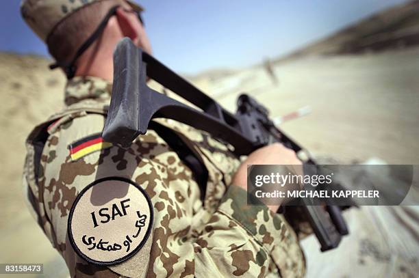 Picture taken on September 10, 2008 shows a soldier of the German Bundeswehr Army controlling at a checkpoint on a road near Kunduz in northern...