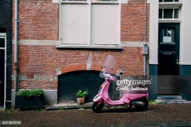 moped parked on european street - vespa stock pictures, royalty-free photos & images