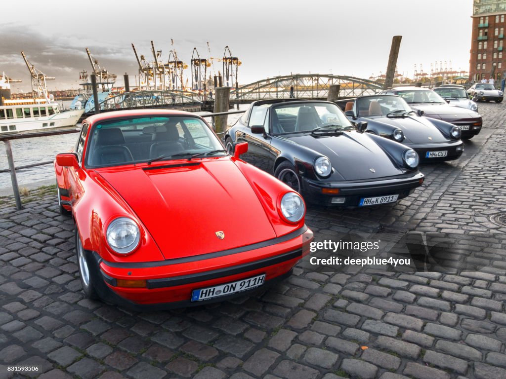 A row of parked Porsche 911 vehicles during the event with Magnus Walker on the Fish Market Hamburg