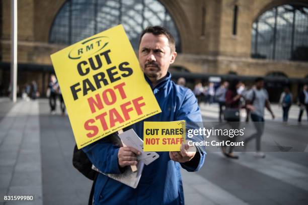 National Union of Rail, Maritime and Transport Workers member take part in a protest against rail fare increases on August 15, 2017 at King's Cross...