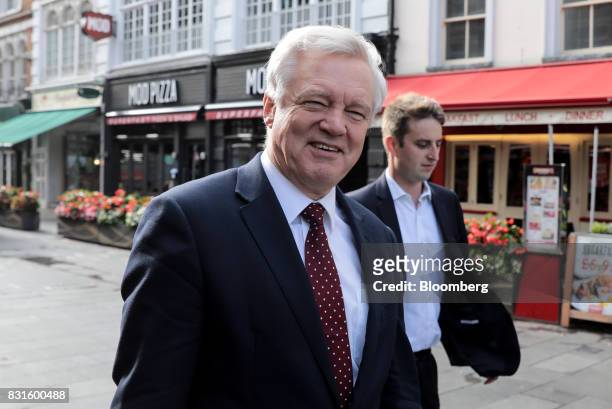 David Davis, U.K. Exiting the European Union secretary, left, walks in-between doing media interviews in London, U.K., on Tuesday, Aug. 15, 2017. The...