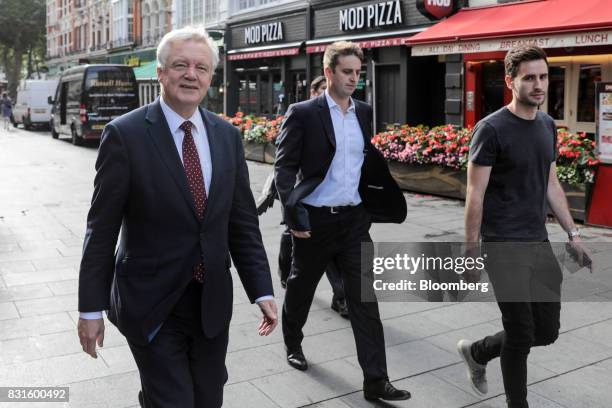 David Davis, U.K. Exiting the European Union secretary, left, walks in-between doing media interviews in London, U.K., on Tuesday, Aug. 15, 2017. The...