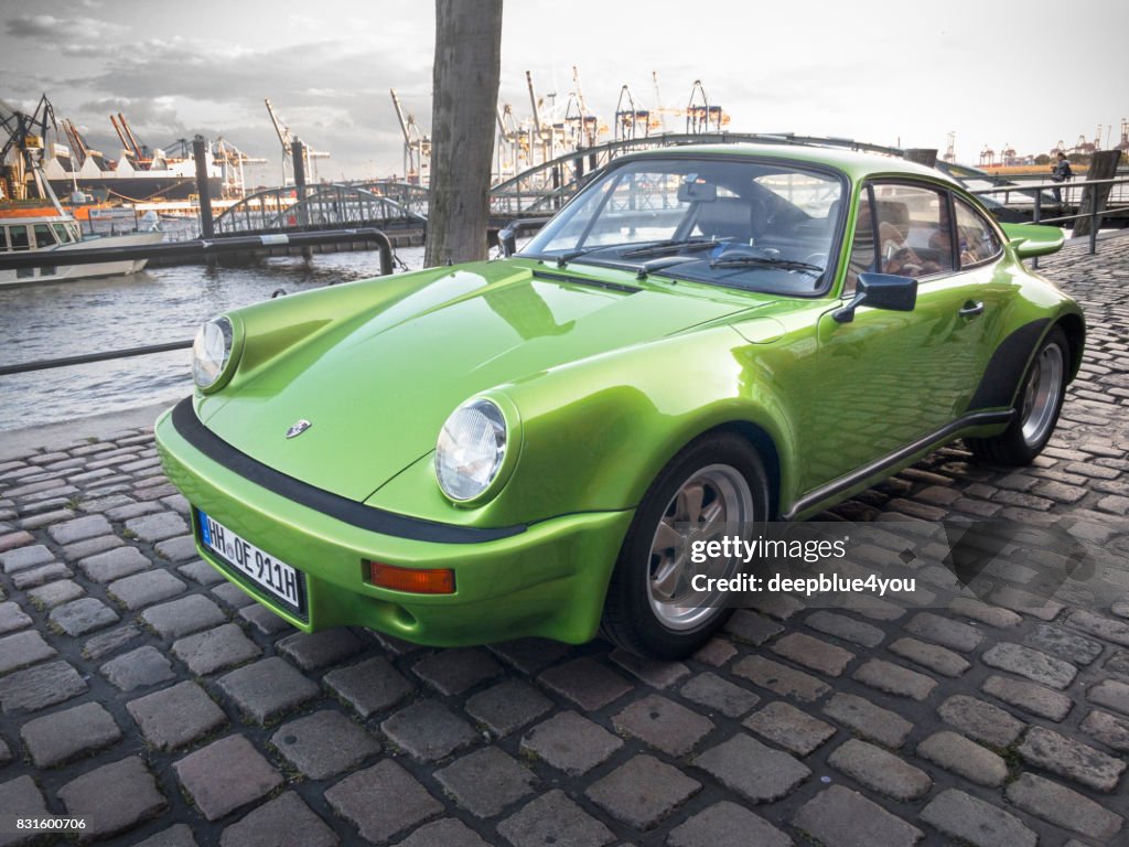 Green Porsche 911 parked during the event with Magnus Walker on the Fish Market Hamburg