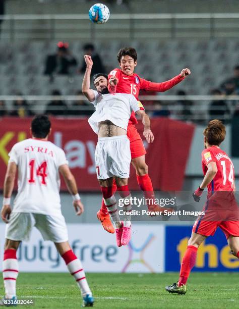 Hong Jeongho of Korea Republic fights for the ball with Omar Kharbin of Syria during their 2018 FIFA World Cup Russia Final Qualification Round Group...