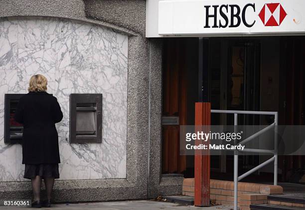 Woman withdraws money from a cashpoint ATM outside a branch of HSBC Bank on October 7, 2008 in Bristol, England. Financial markets continue to...