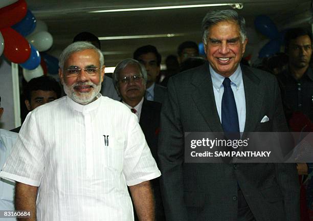 Chairman of Indian auto makers Tata Motors, Ratan Tata walks alongside chief minister of the Indian stet of Gujarat Narendra Modi prior to the...