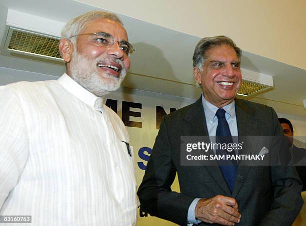 Chairman of Indian auto makers Tata Motors, Ratan Tata poses for a photograph alongside chief minister of the Indian state of Gujarat Narendra Modi...