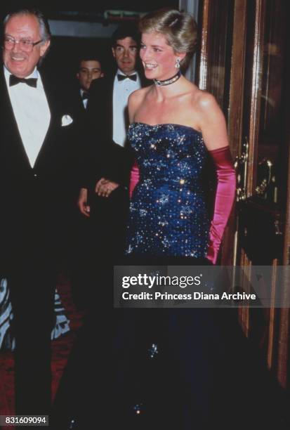 Diana, Princess of Wales wearing a navy blue Murray Arbeid dress and shocking pink long gloves, attends theatre gala of 'Phantom of the Opera',...