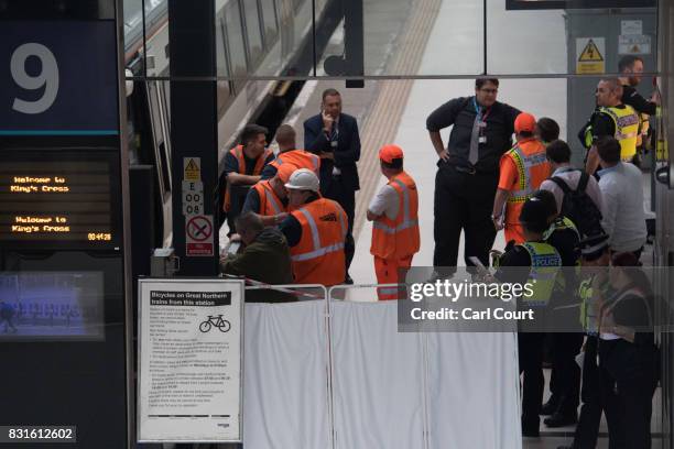 Rail staff attend the scene of an incident at King's Cross Station in which a train is believed to have hit the buffers on August 15, 2017 in London,...