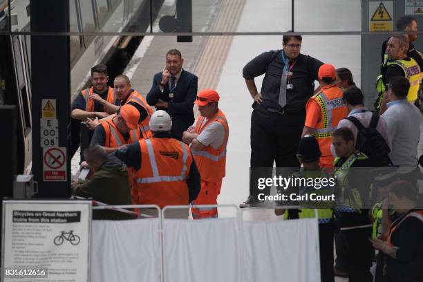 Rail staff attend the scene of an incident at King's Cross Station in which a train is believed to have hit the buffers on August 15, 2017 in London,...