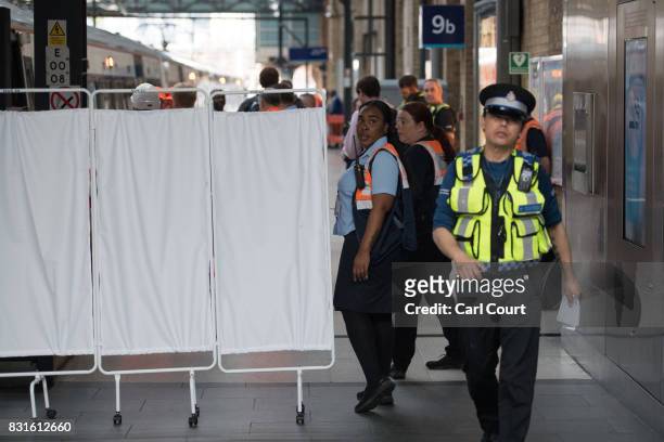 Rail staff attend the scene of an incident at King's Cross Station in which a train is believed to have hit the buffers on August 15, 2017 in London,...