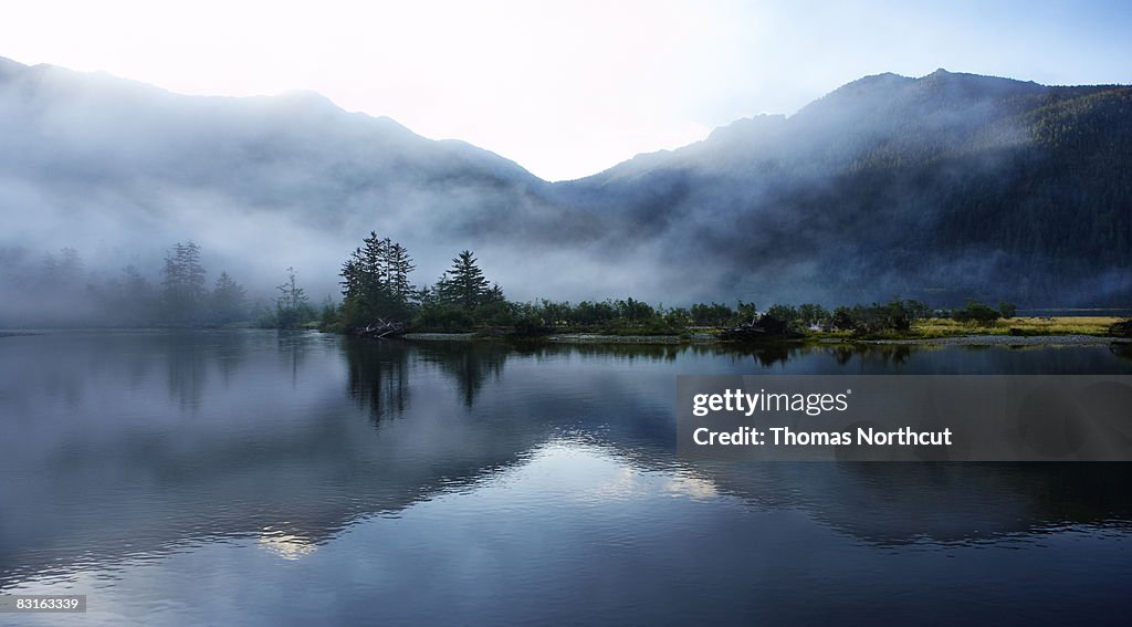 Morning light and mist across sound and mountains