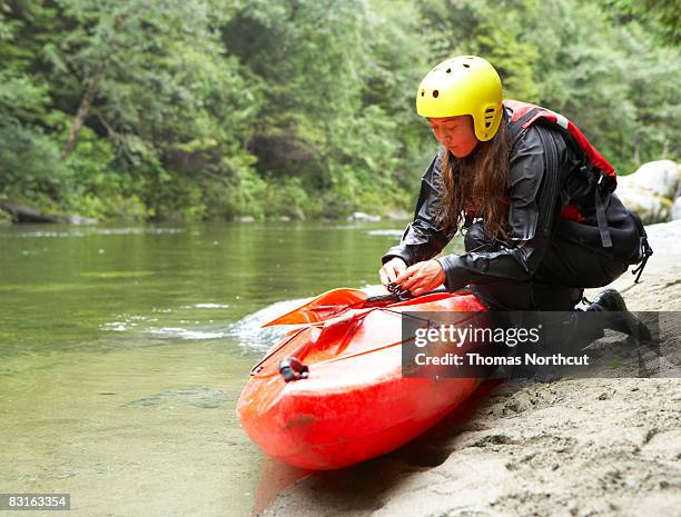 woman preparing her kayak. - canoeing and kayaking stock pictures, royalty-free photos & images