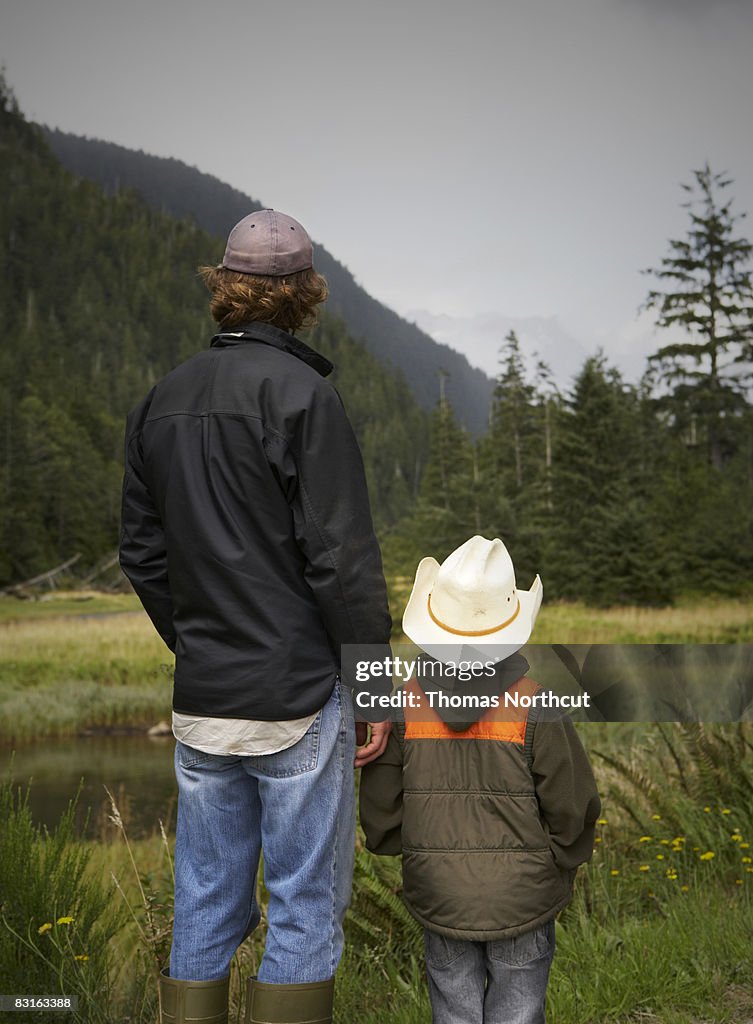 Pai e filho Olhando para a Rio e tidal marsh