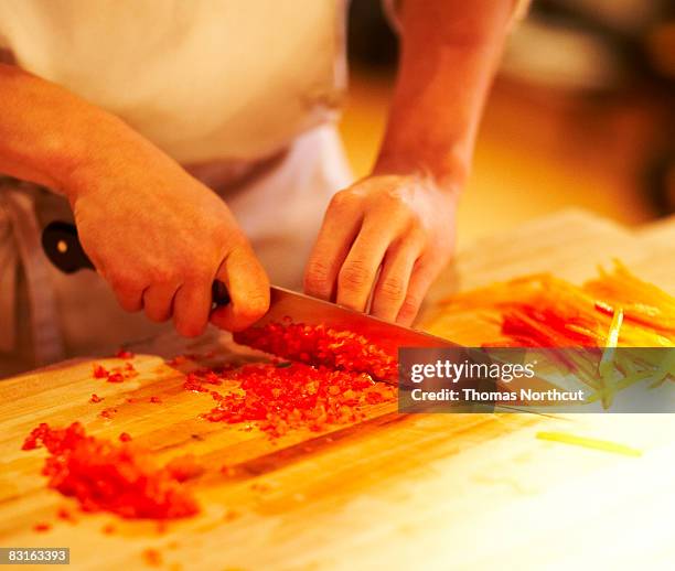 chef mincing bell peppers with knife - mincing knife stock pictures, royalty-free photos & images