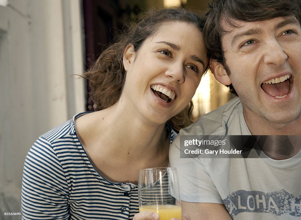 Couple laughing away from camera