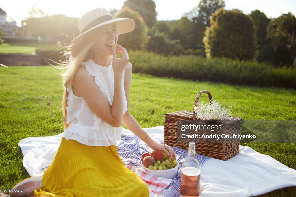 Young woman having picnic in park
