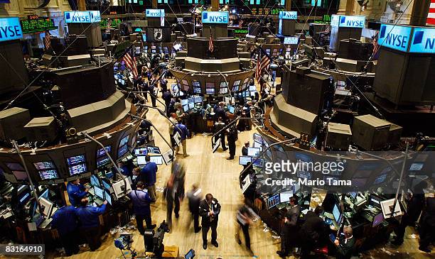 Traders work on the floor of the New York Stock Exchange October 7, 2008 in New York City. Despite a government debt buyout plan, the Dow continued...