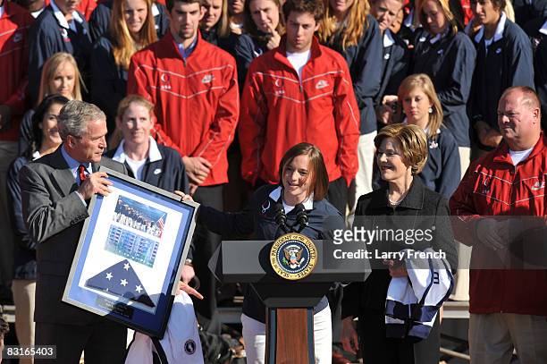 United States Olympic team paralympian Melissa Stockwell presents President George W. Bush and First Lady Laura Bush with the United States flag that...
