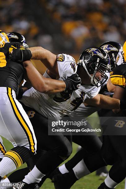 Defensive lineman Justin Bannan of the Baltimore Ravens battles offensive linemen of the Pittsburgh Steelers during a game at Heinz Field on...