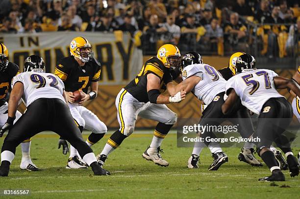 Quarterback Ben Roethlisberger of the Pittsburgh Steelers drops back to pass as center Justin Hartwig blocks defensive lineman Justin Bannan of the...
