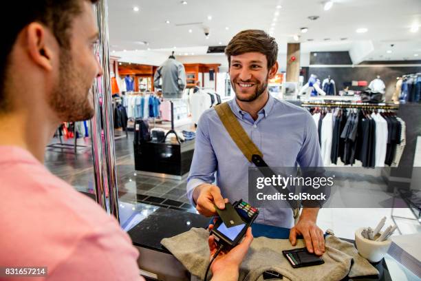 making a contactless payment - men fashion stock pictures, royalty-free photos & images