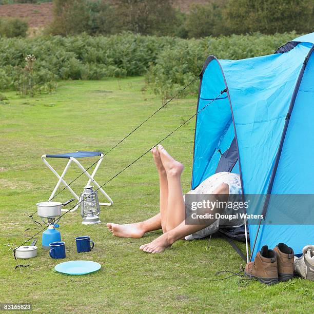 young couple laying together in tent. - table romantique photos et images de collection