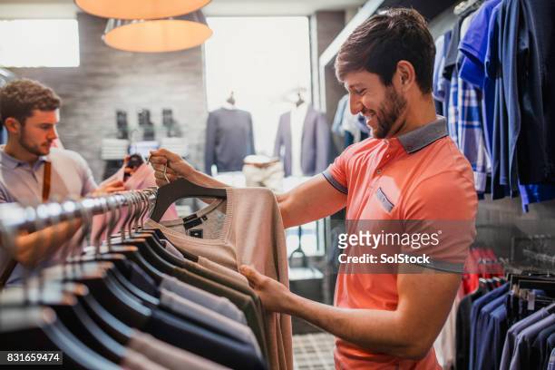 picking out a new jumper - british menswear originals stock pictures, royalty-free photos & images