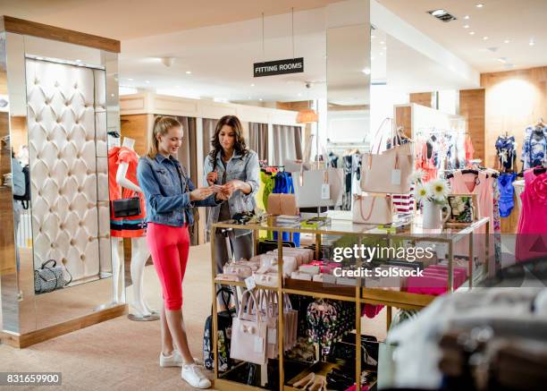 females shopping in the accessories department - handbag store stock pictures, royalty-free photos & images