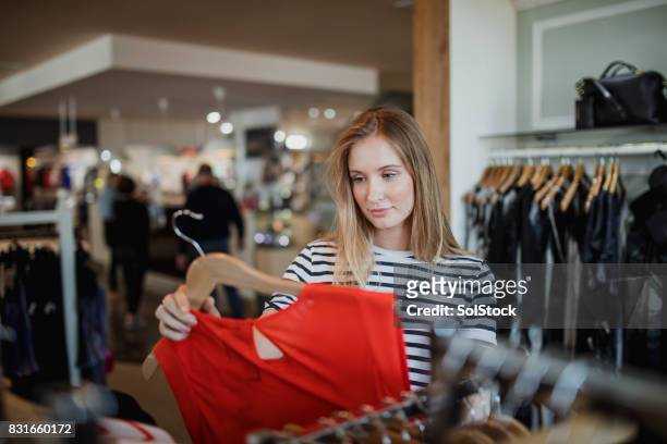 spoiling herself with new cothes - fashion store stock pictures, royalty-free photos & images