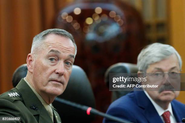 Chairman of the US Joint Chiefs of Staff, General Joseph Dunford , speaks as US Ambassador to China Terry Branstad looks on during a meeting at the...