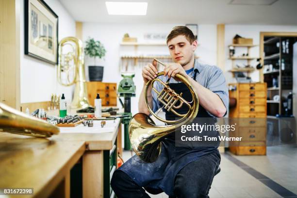 Apprentice Working On Musical Instrument Build In Workshop