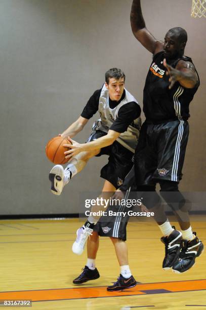 Goran Dragic passes around Shaquille O'Neal of the Phoenix Suns during NBA TV's Real Training Camp visit to the Phoenix Suns on October 7 at U.S....