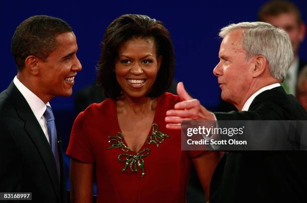 Democratic presidential candidate Sen. Barack Obama and his wife Michelle Obama speak to debate moderator Tom Brokaw after the Town Hall Presidential...