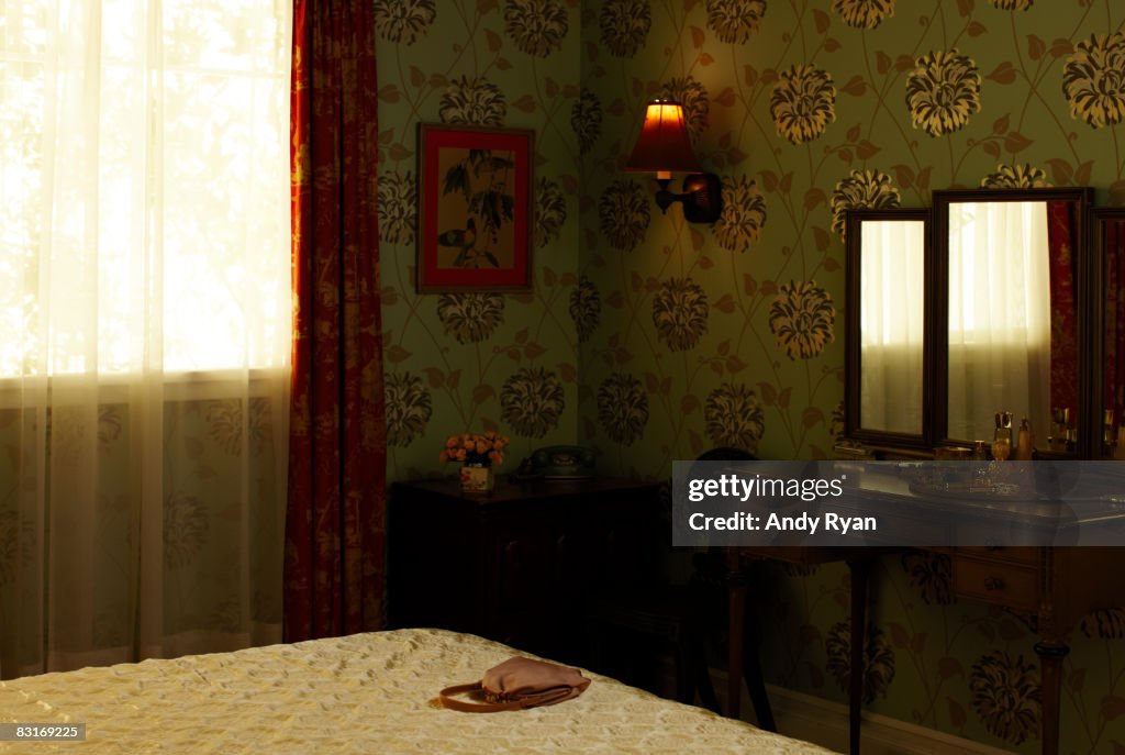 Purse on bed in 1960's style bedroom