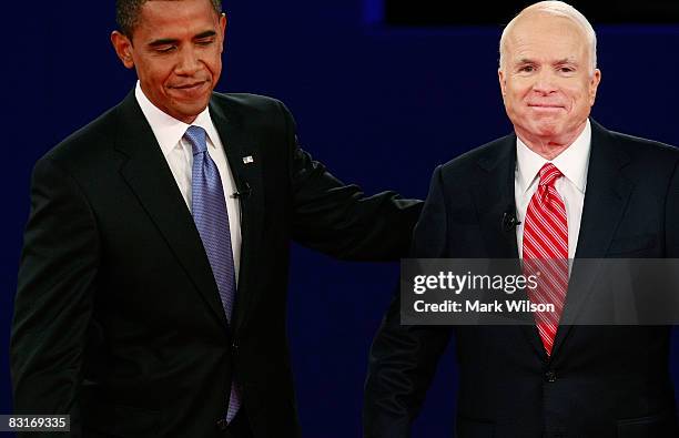 Republican presidential candidate Sen. John McCain and Democratic presidential candidate Sen. Barack Obama poses on stage after the Town Hall...