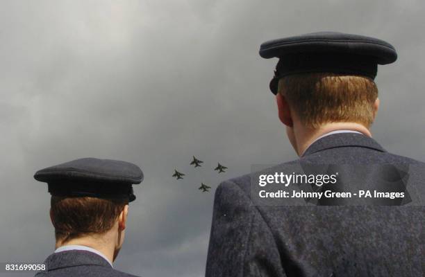 Two RAF servicemen watch four SEPECAT Jaguar GR3 aircraft take off from RAF Coltishall in Norfolk, Saturday April 1, 2006. The aircrafts are the last...
