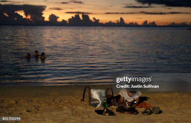 Young boy plays on a cell phone on Tumon Beach on August 15, 2017 in Tamuning, Guam. The American territory of Guam remains on high alert as a...