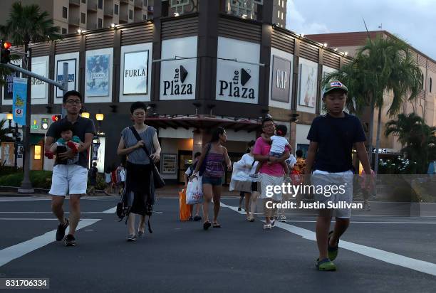 Pedestrians cross the street on Pale San Vitores Road on August 15, 2017 in Tamuning, Guam. The American territory of Guam remains on high alert as a...