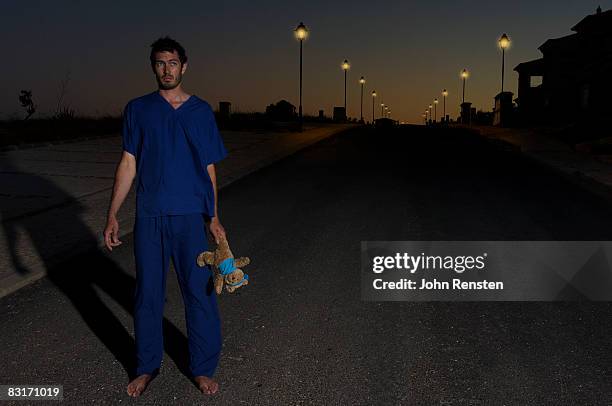 man at night with teddy bear - stuffed toy stock pictures, royalty-free photos & images