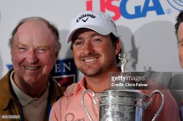 Northern Irish golfer Graeme McDowell poses with his trophy after winning the 110th US Open golf championship, Pebble Beach, California, June 20,...